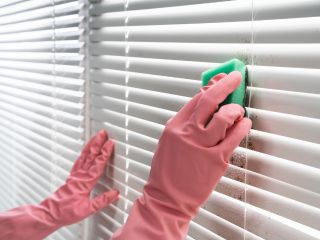 How to clean blinds and other window coverings? | Master Window Shade CA Person using a microfiber cloth to clean blinds